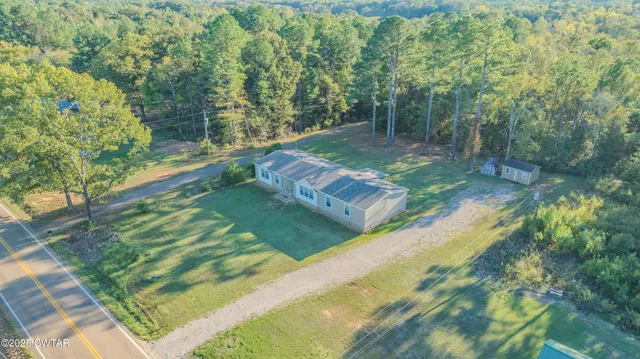 a view of a yard with large trees