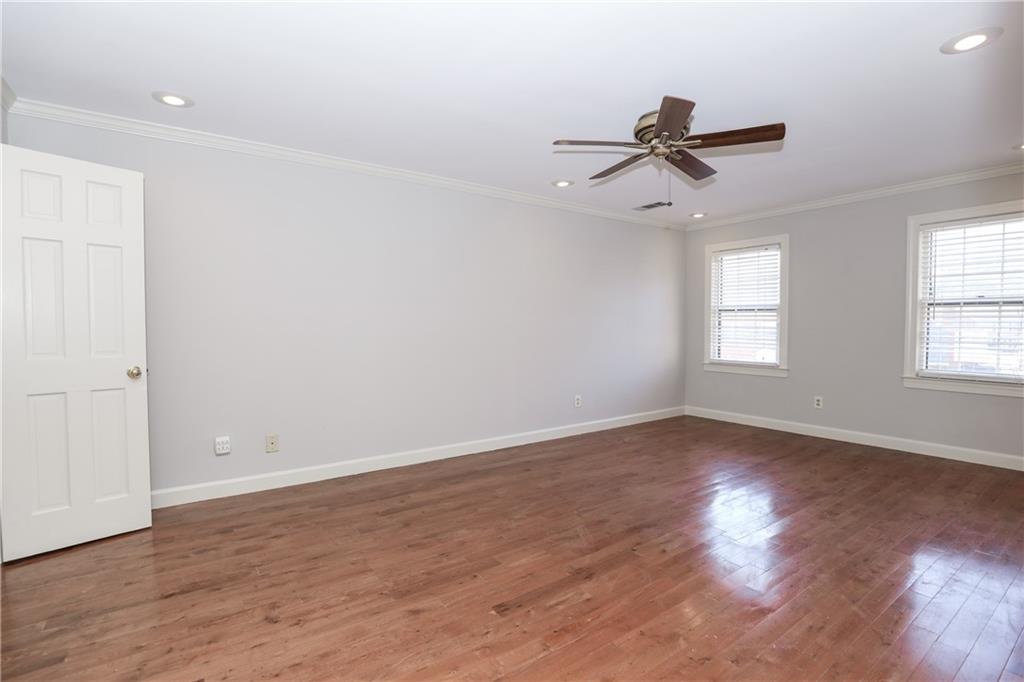 3122 Henderson Walk Atlanta, GA 30340 - Photo 27 of 70 an empty room with wooden floor ceiling fan and windows