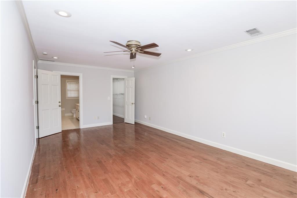 3122 Henderson Walk Atlanta, GA 30340 - Photo 28 of 70 a view of an empty room with wooden floor and a ceiling fan