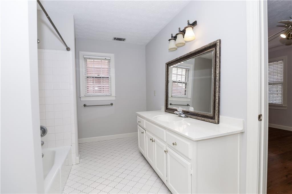 3122 Henderson Walk Atlanta, GA 30340 - Photo 40 of 70 a bathroom with a sink a vanity and a mirror