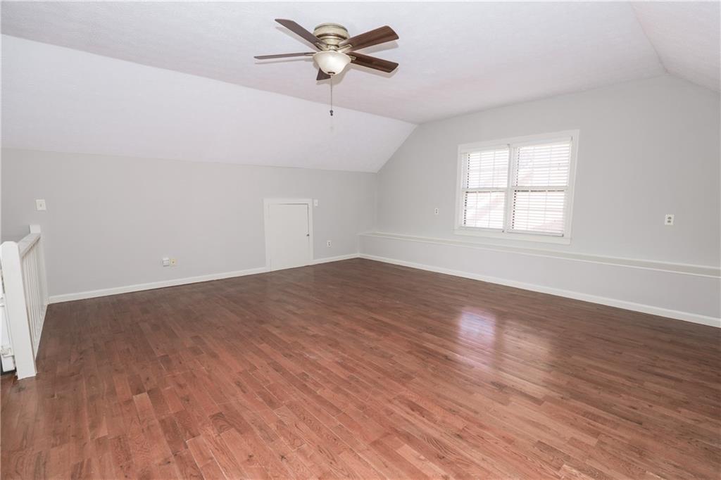 3122 Henderson Walk Atlanta, GA 30340 - Photo 53 of 70 an empty room with wooden floor fan and windows