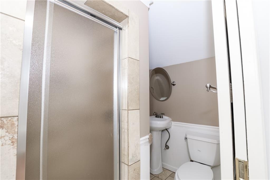 3122 Henderson Walk Atlanta, GA 30340 - Photo 60 of 70 a white toilet sitting next to a bathroom sink
