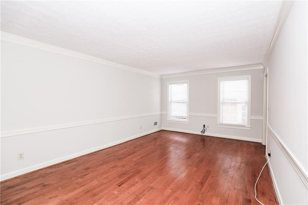 3122 Henderson Walk Atlanta, GA 30340 - Photo 8 of 70 an empty room with wooden floor and windows