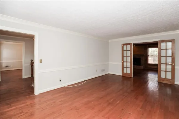 a view of a room with wooden floor and ceiling fan