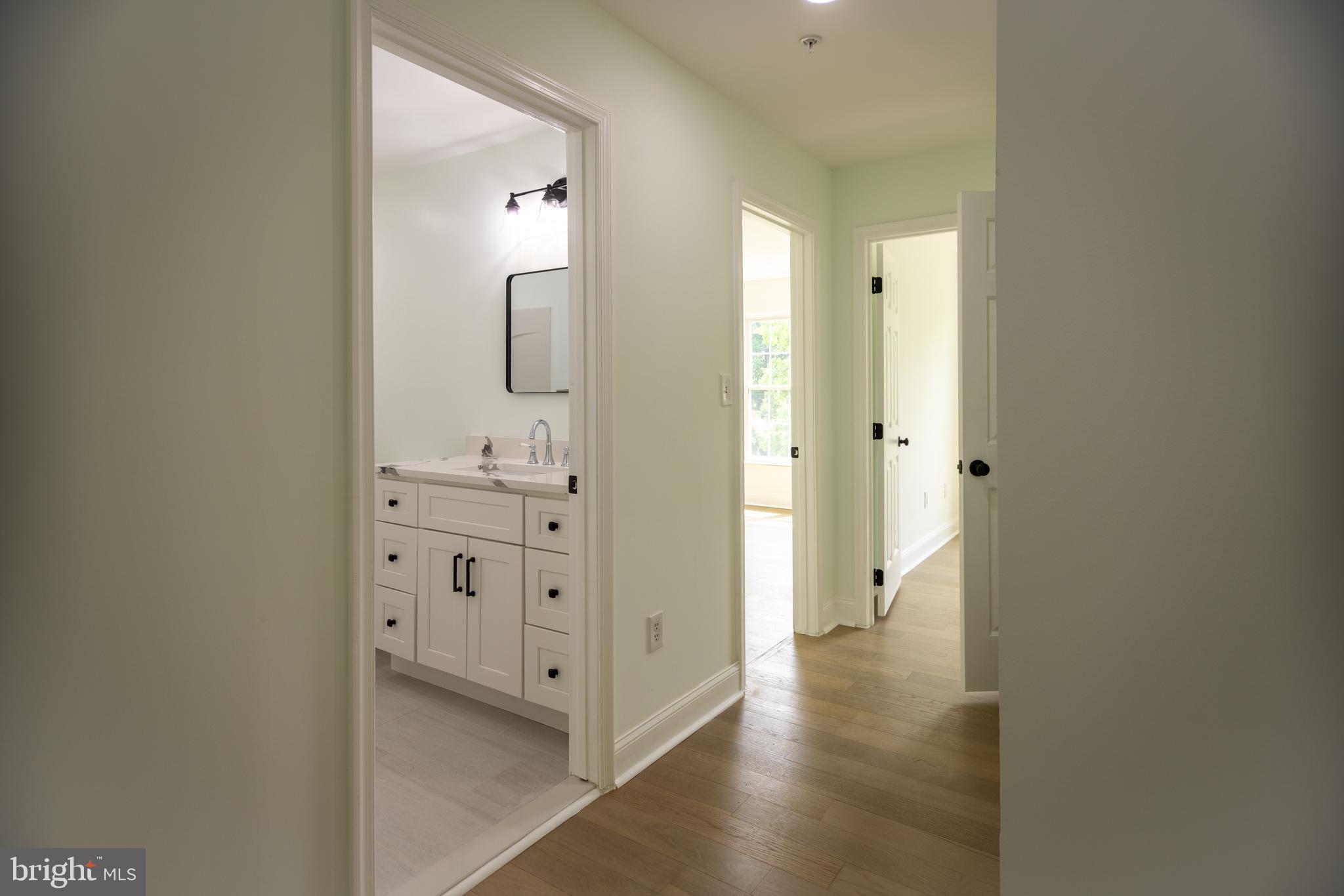 11904 White Heather Road Cockeysville, MD 21030 - Photo 13 of 42 a bathroom with a double vanity sink and mirror