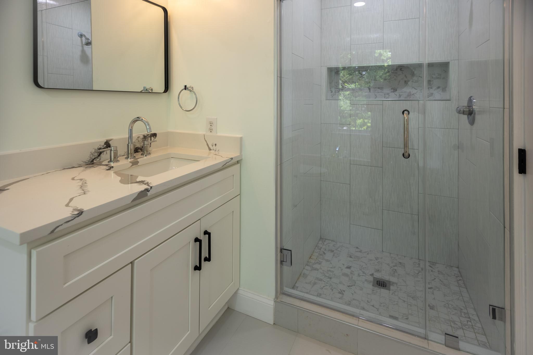 11904 White Heather Road Cockeysville, MD 21030 - Photo 17 of 42 a bathroom with a granite countertop sink a mirror and shower