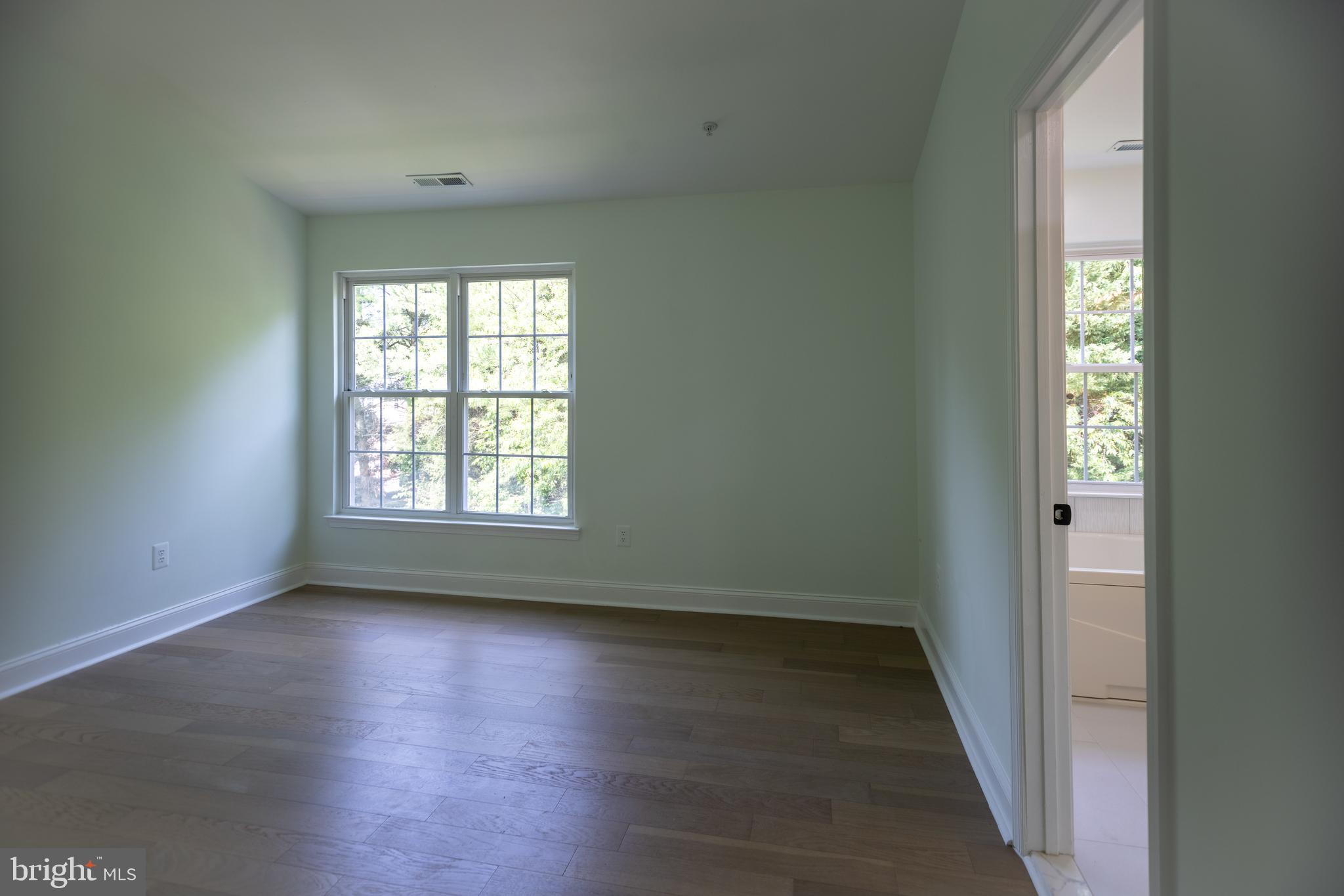 11904 White Heather Road Cockeysville, MD 21030 - Photo 20 of 42 an empty room with wooden floor and windows