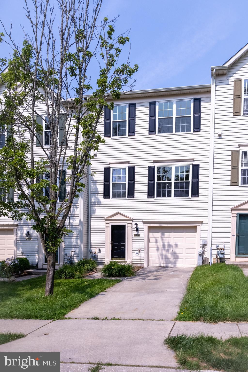 11904 White Heather Road Cockeysville, MD 21030 - Photo 2 of 42 a front view of a house with a garden