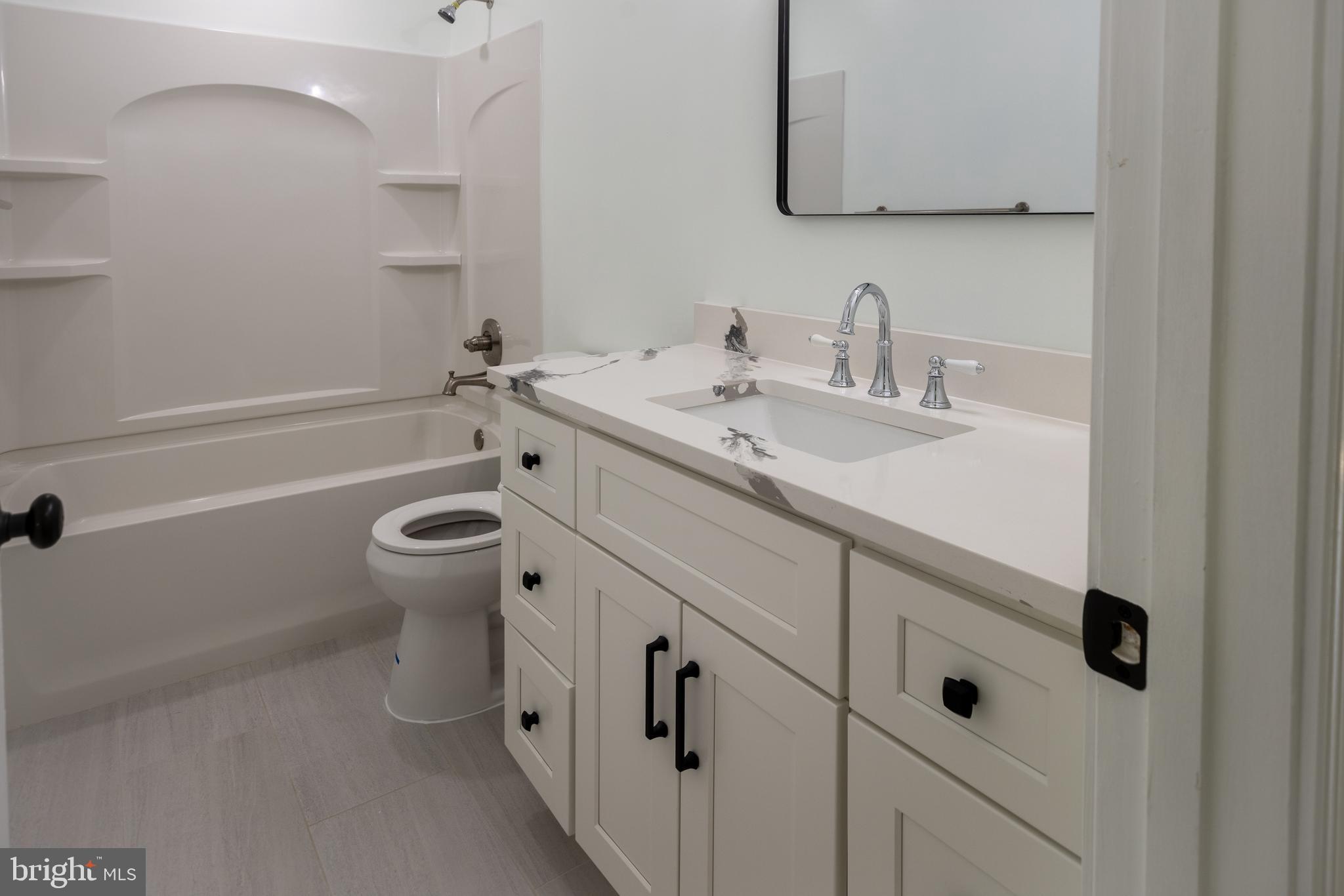 11904 White Heather Road Cockeysville, MD 21030 - Photo 21 of 42 a bathroom with a sink a toilet and shower