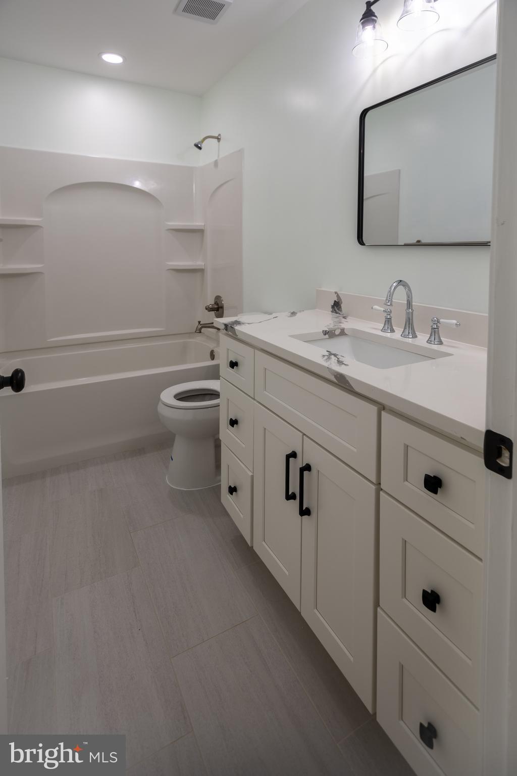 11904 White Heather Road Cockeysville, MD 21030 - Photo 22 of 42 a bathroom with a toilet sink double vanity and mirror