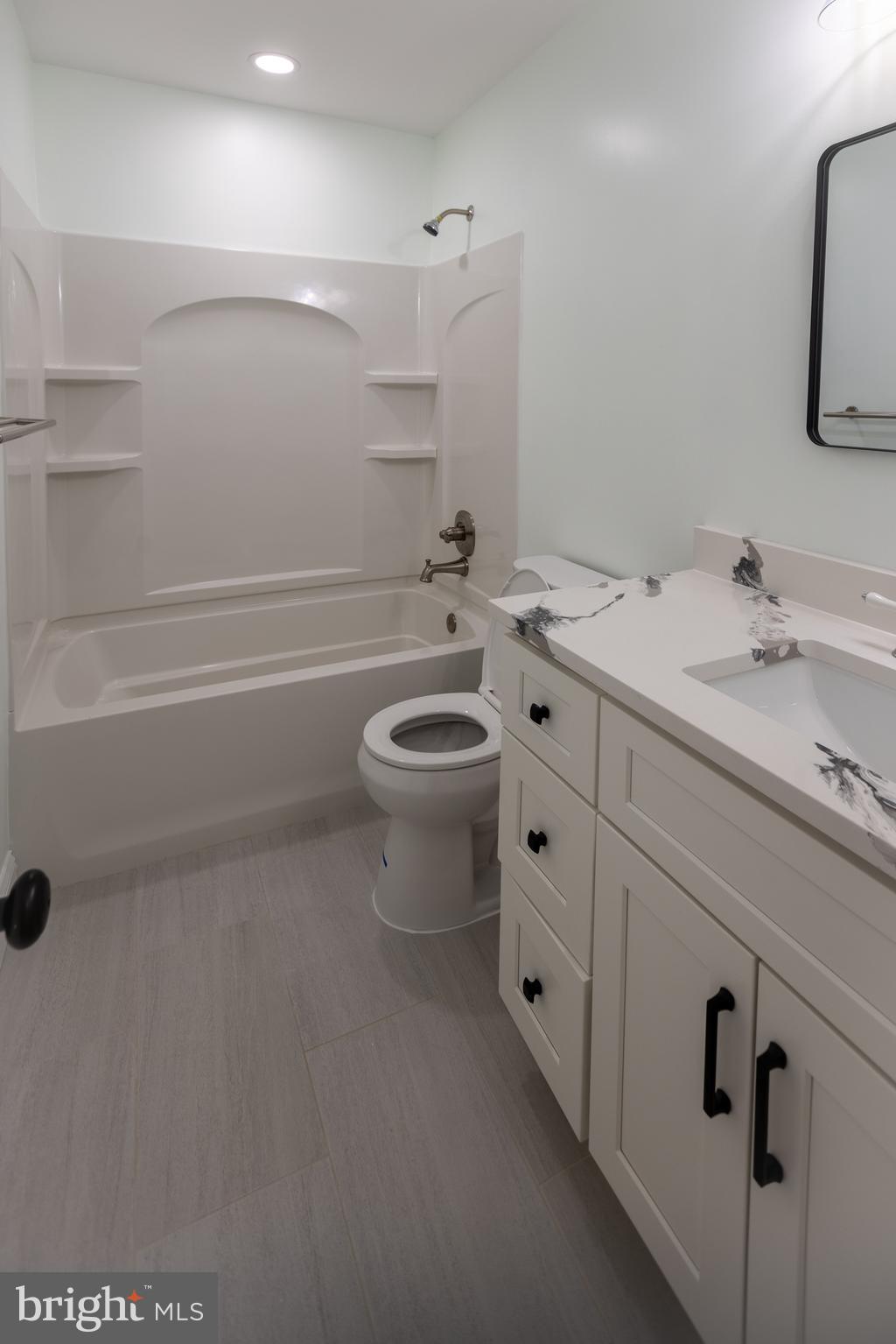 11904 White Heather Road Cockeysville, MD 21030 - Photo 23 of 42 a bathroom with a double vanity sink a toilet a mirror and shower