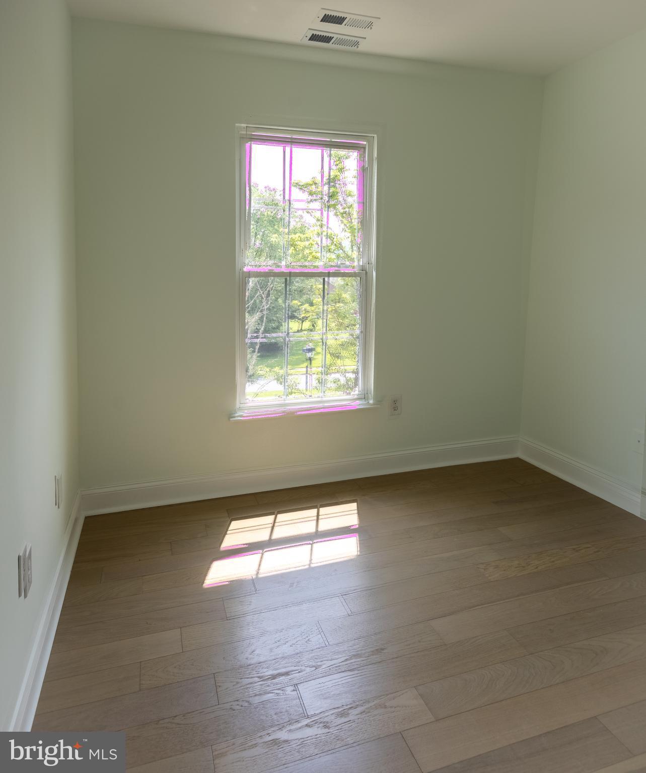 11904 White Heather Road Cockeysville, MD 21030 - Photo 28 of 42 an empty room with wooden floor and windows