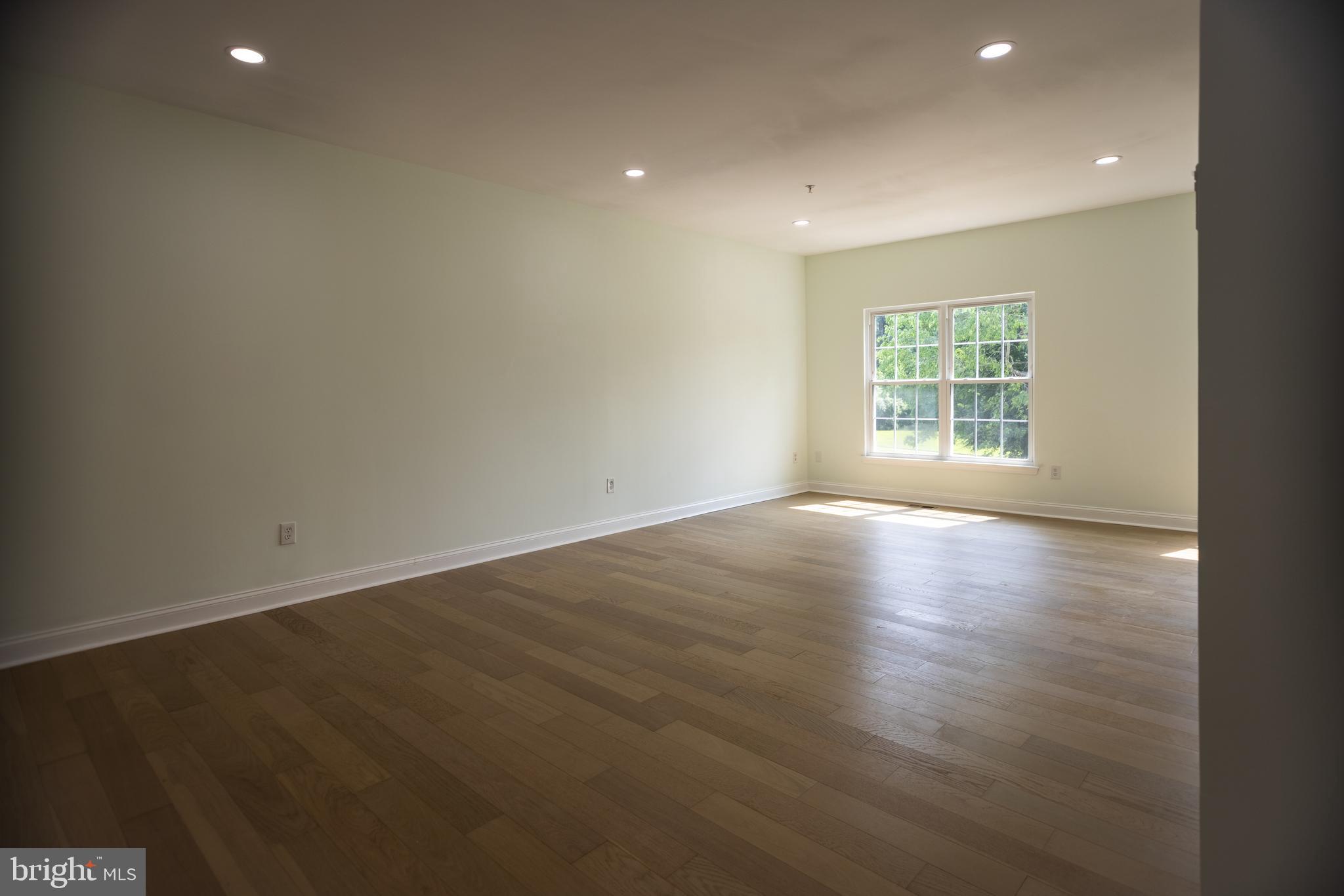 11904 White Heather Road Cockeysville, MD 21030 - Photo 3 of 42 an empty room with wooden floor and windows
