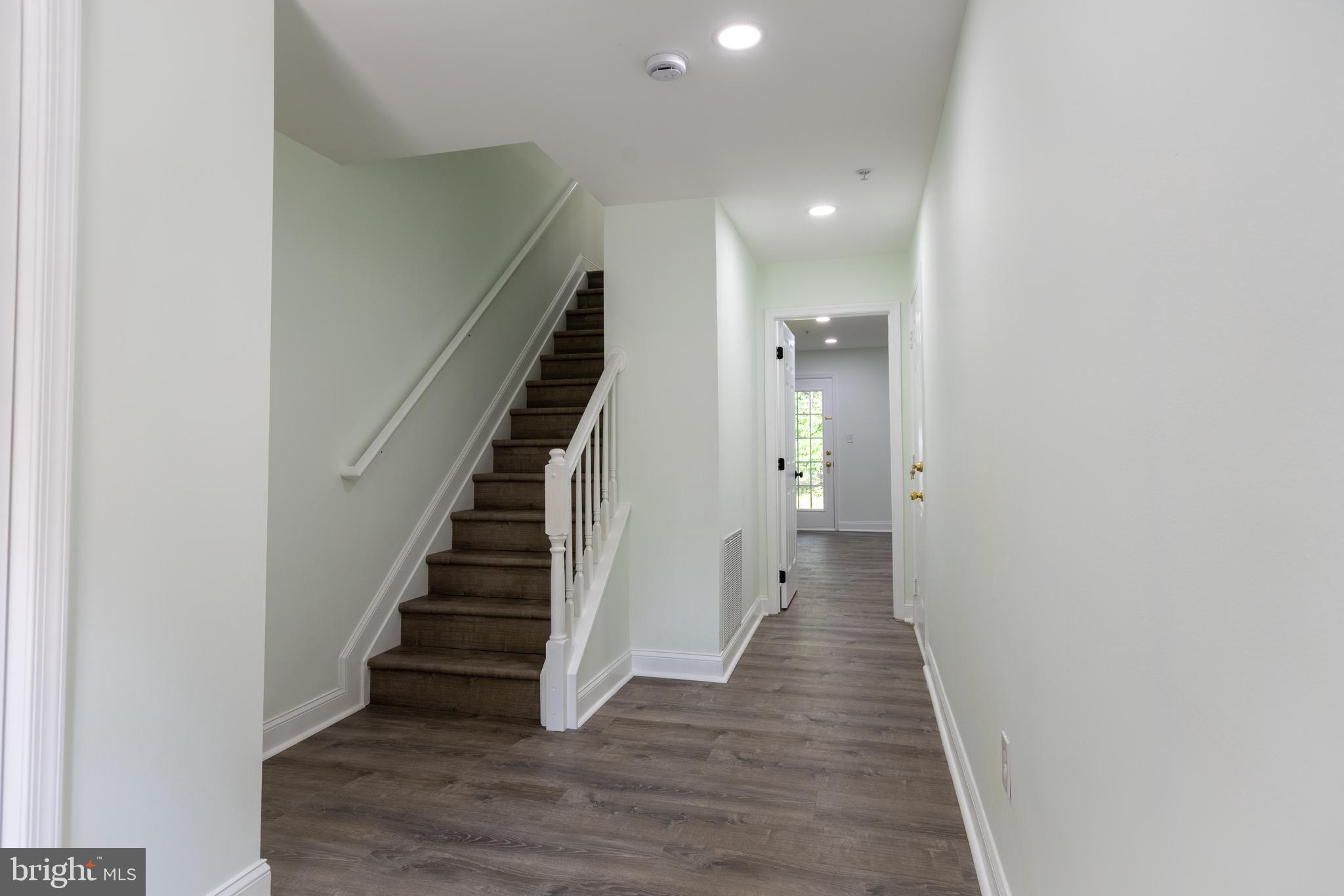 11904 White Heather Road Cockeysville, MD 21030 - Photo 33 of 42 a view of a hallway with wooden floor and entryway