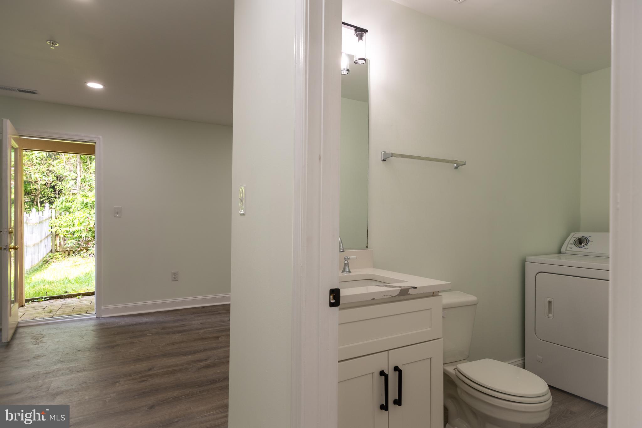 11904 White Heather Road Cockeysville, MD 21030 - Photo 35 of 42 a bathroom with a sink a toilet and a window