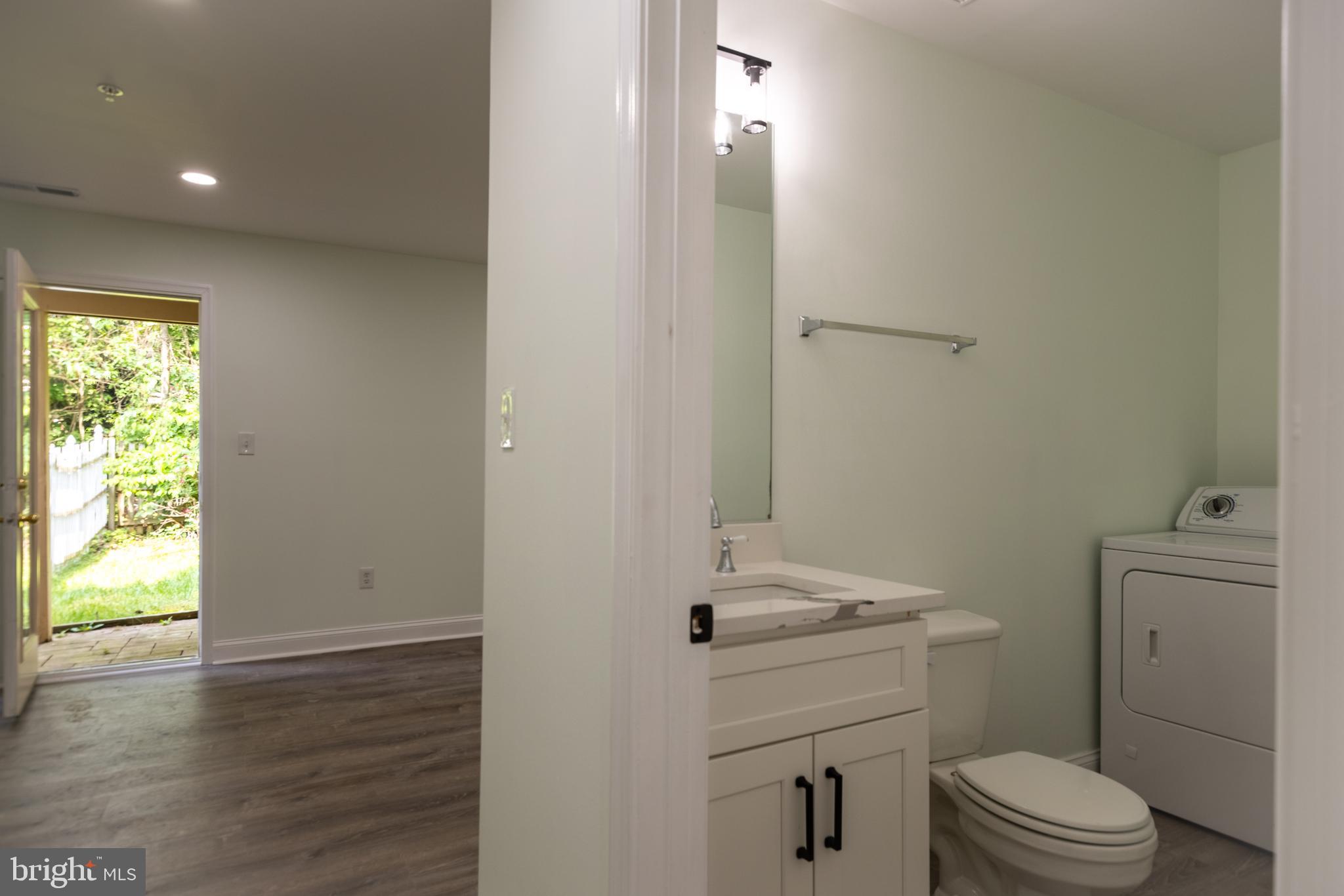 11904 White Heather Road Cockeysville, MD 21030 - Photo 36 of 42 a bathroom with a sink a toilet and a window