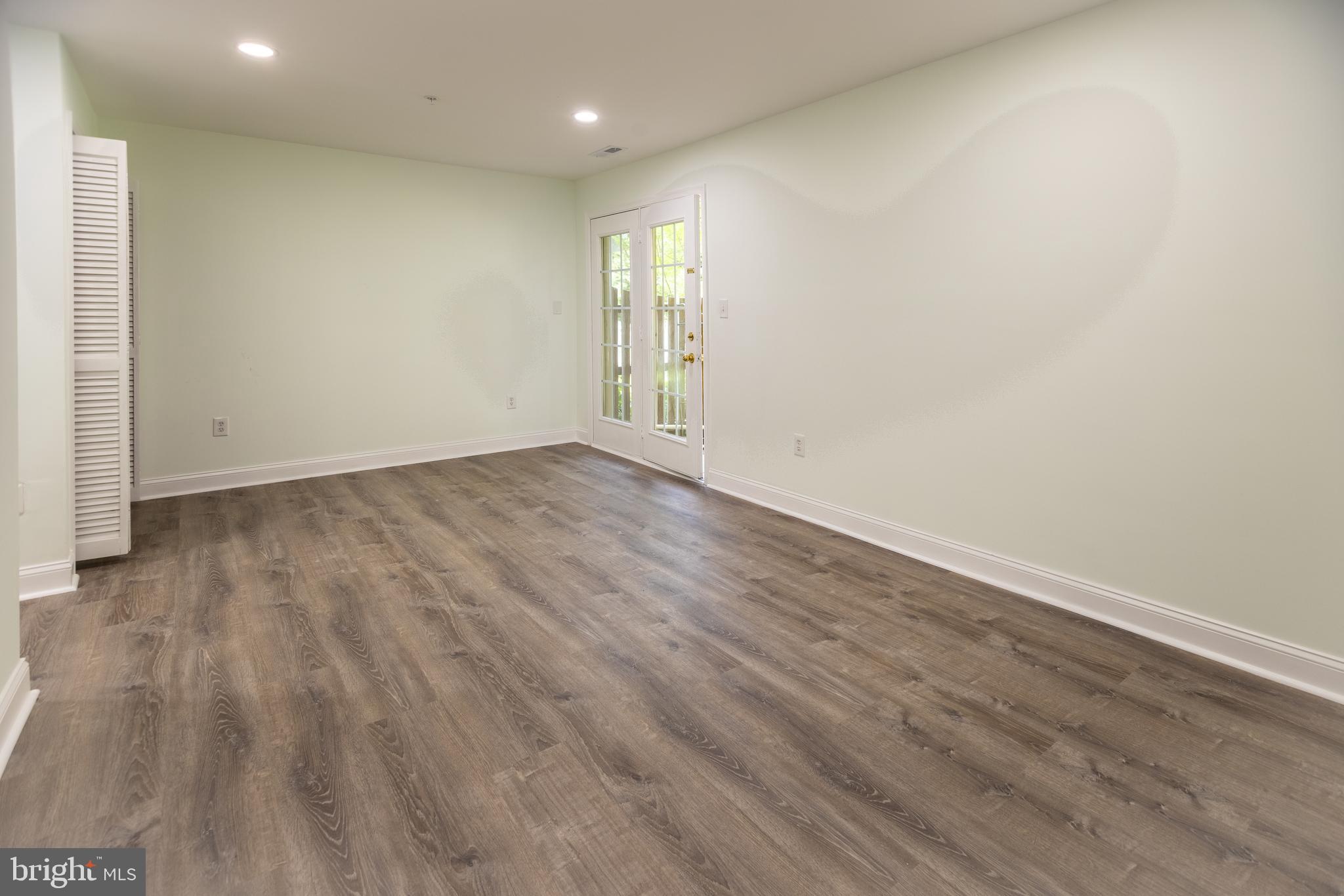 11904 White Heather Road Cockeysville, MD 21030 - Photo 39 of 42 a view of an empty room with wooden floor and a window