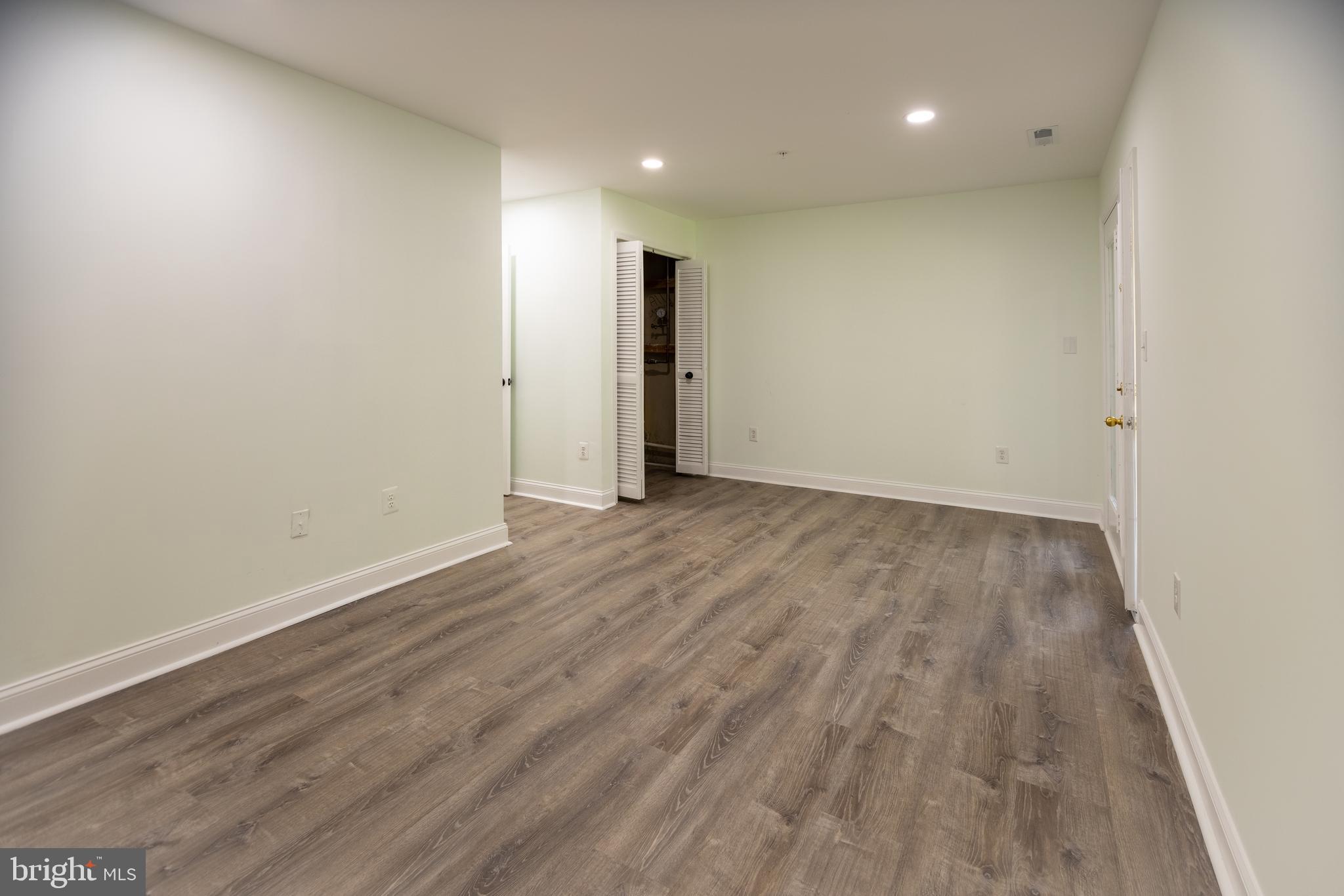 11904 White Heather Road Cockeysville, MD 21030 - Photo 40 of 42 a view of an empty room with wooden floor