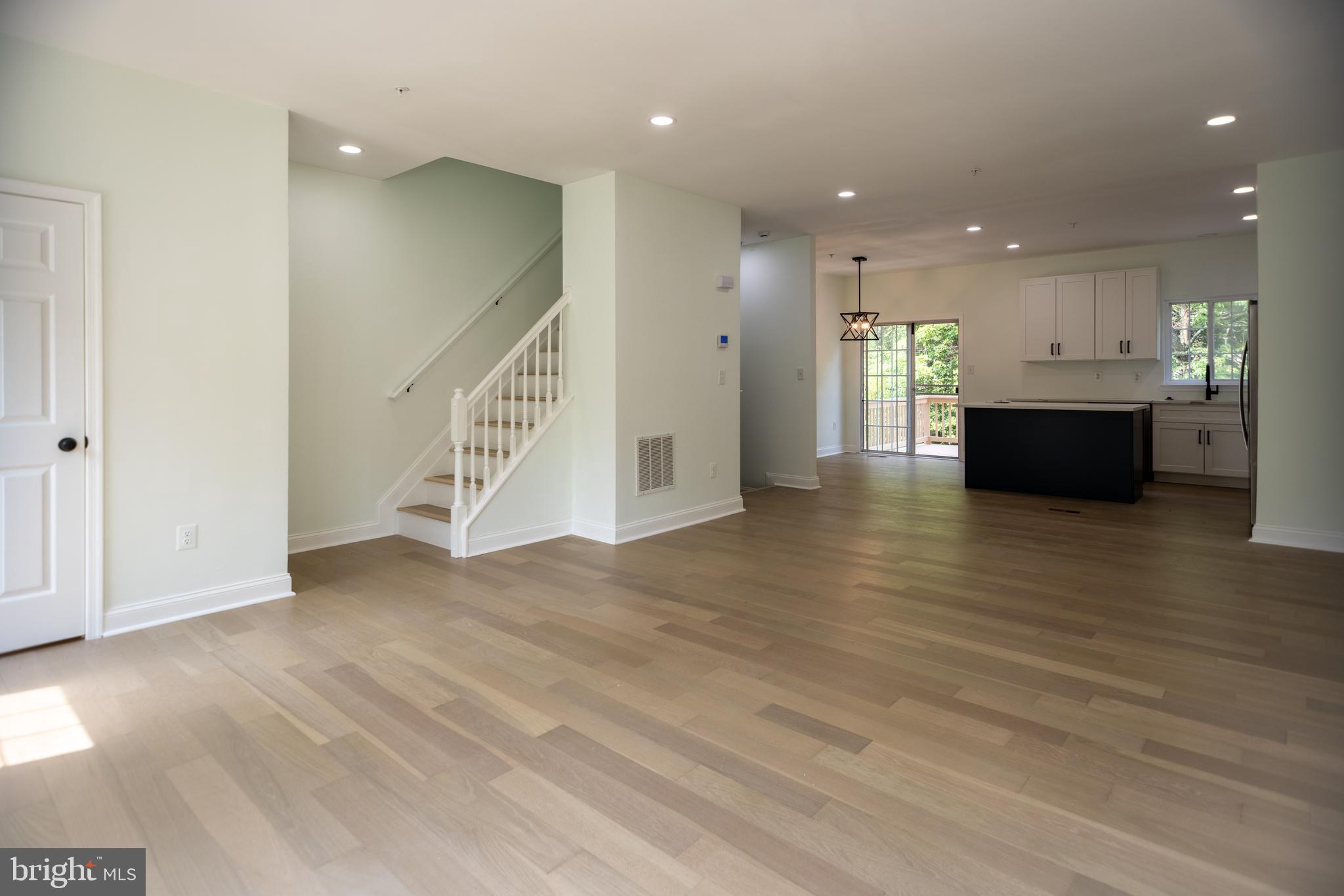 11904 White Heather Road Cockeysville, MD 21030 - Photo 4 of 42 a view of an empty room with wooden floor and staircase