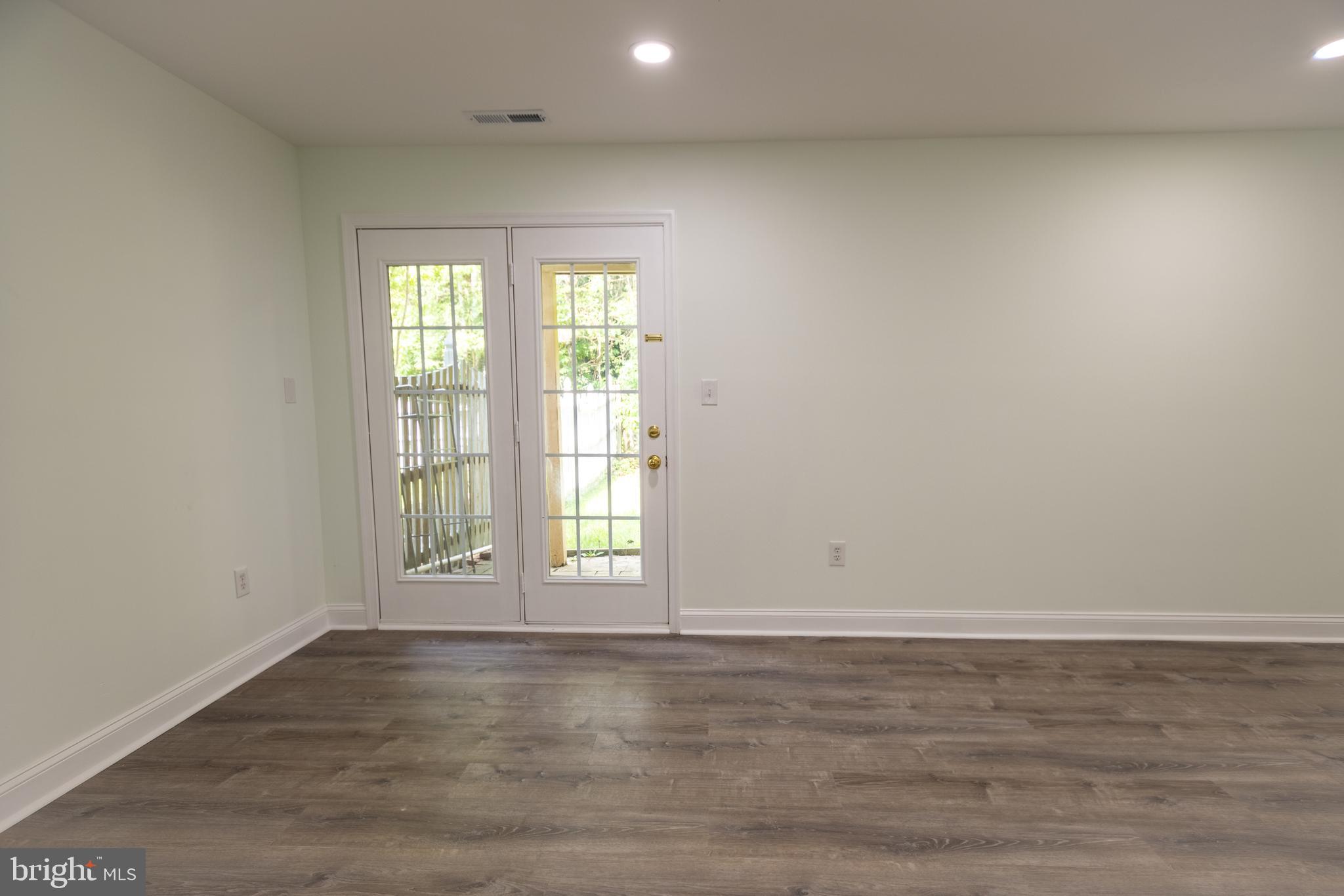 11904 White Heather Road Cockeysville, MD 21030 - Photo 41 of 42 an empty room with wooden floor and windows