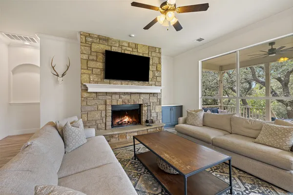 a living room with furniture fireplace and flat screen tv