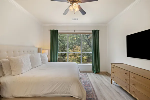 a bedroom with a large bed and a flat screen tv