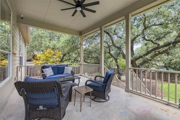 a view of a porch with furniture and a yard