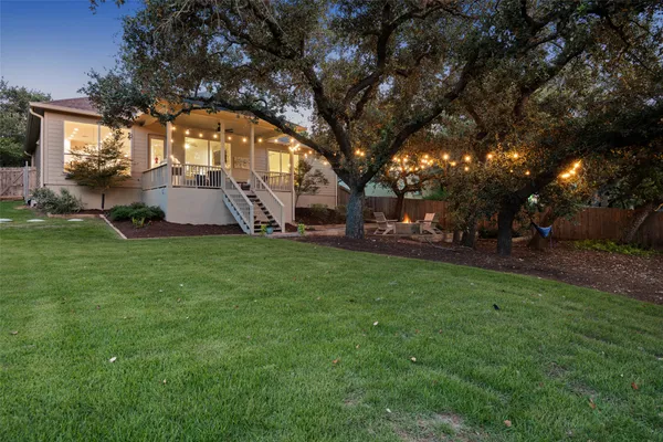 a view of a patio with table and chairs with wooden fence and plants