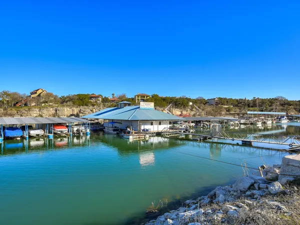 a front view of a house with swimming pool and furniture