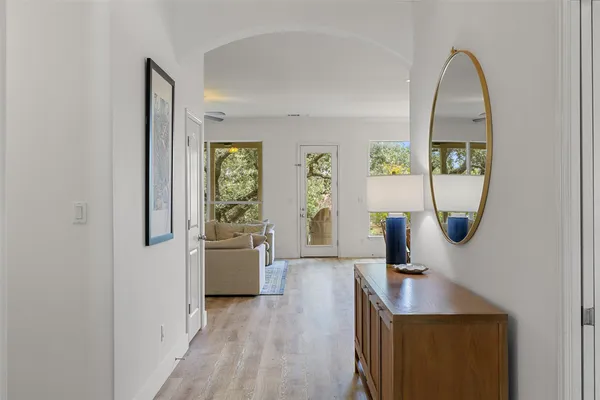 a view of a living room with a window and wooden floor