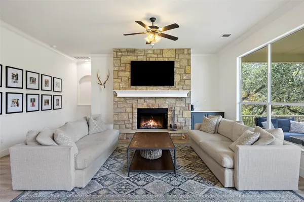 a living room with furniture a fireplace and a flat screen tv
