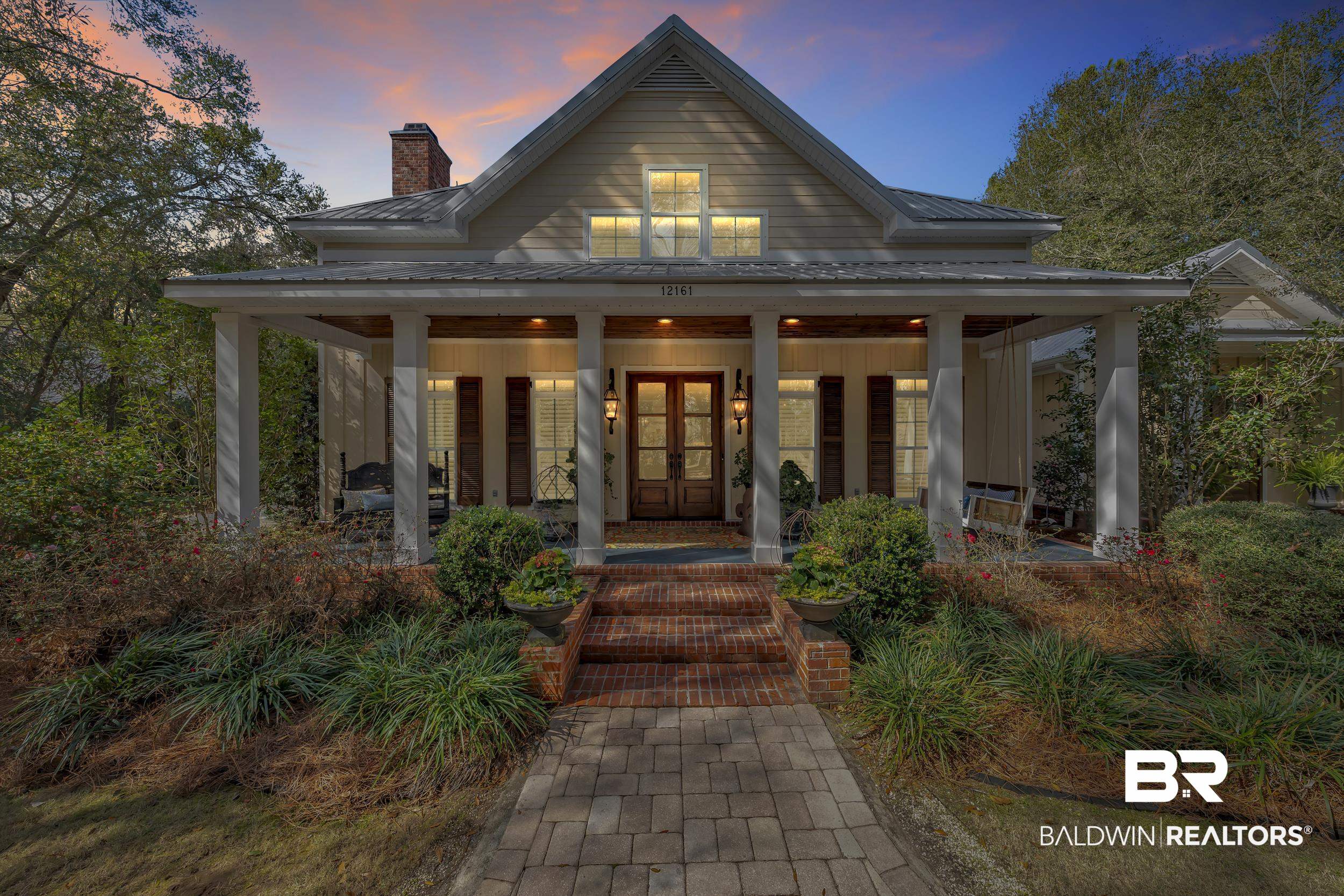 12161 Jessamine Street Magnolia Springs, AL 36555 - Photo 1 of 70 View of front facade with a chimney, covered porch, a metal roof, and french doors