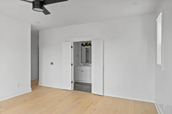 a view of a room with a ceiling fan