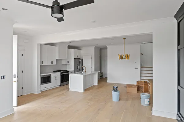a kitchen view of a sink and a stove top oven
