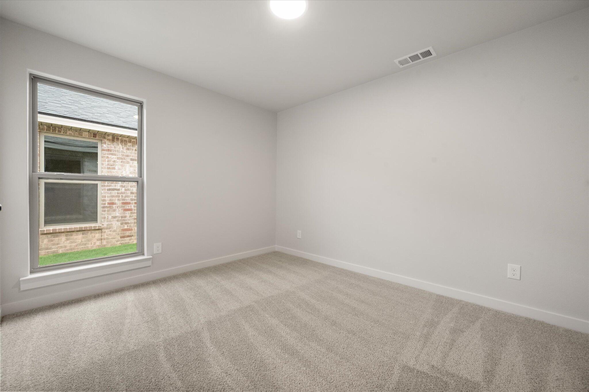 8607 29th Street Lubbock, TX 79407 - Photo 15 of 20 an empty room with a window