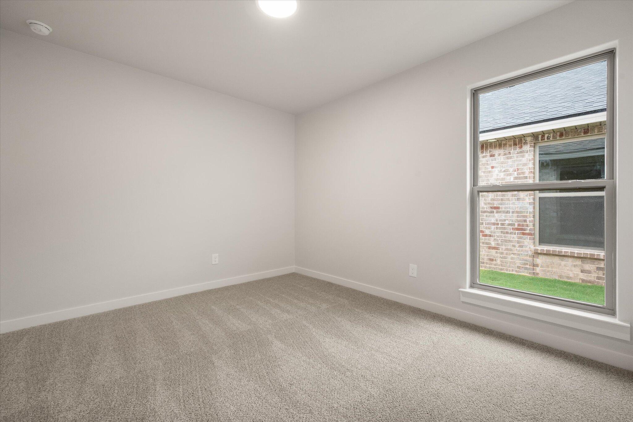 8607 29th Street Lubbock, TX 79407 - Photo 16 of 20 an empty room with a window