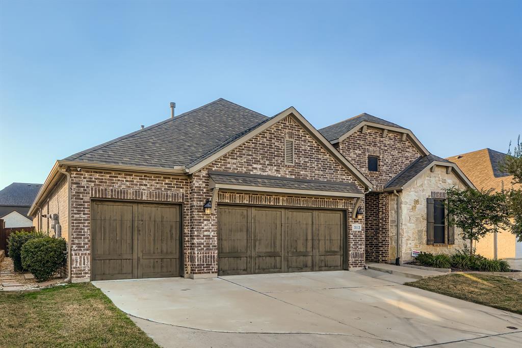 312 Magnolia Drive Oak Point, TX 75068 - Photo 2 of 28 French country home with brick siding, a garage, and concrete driveway