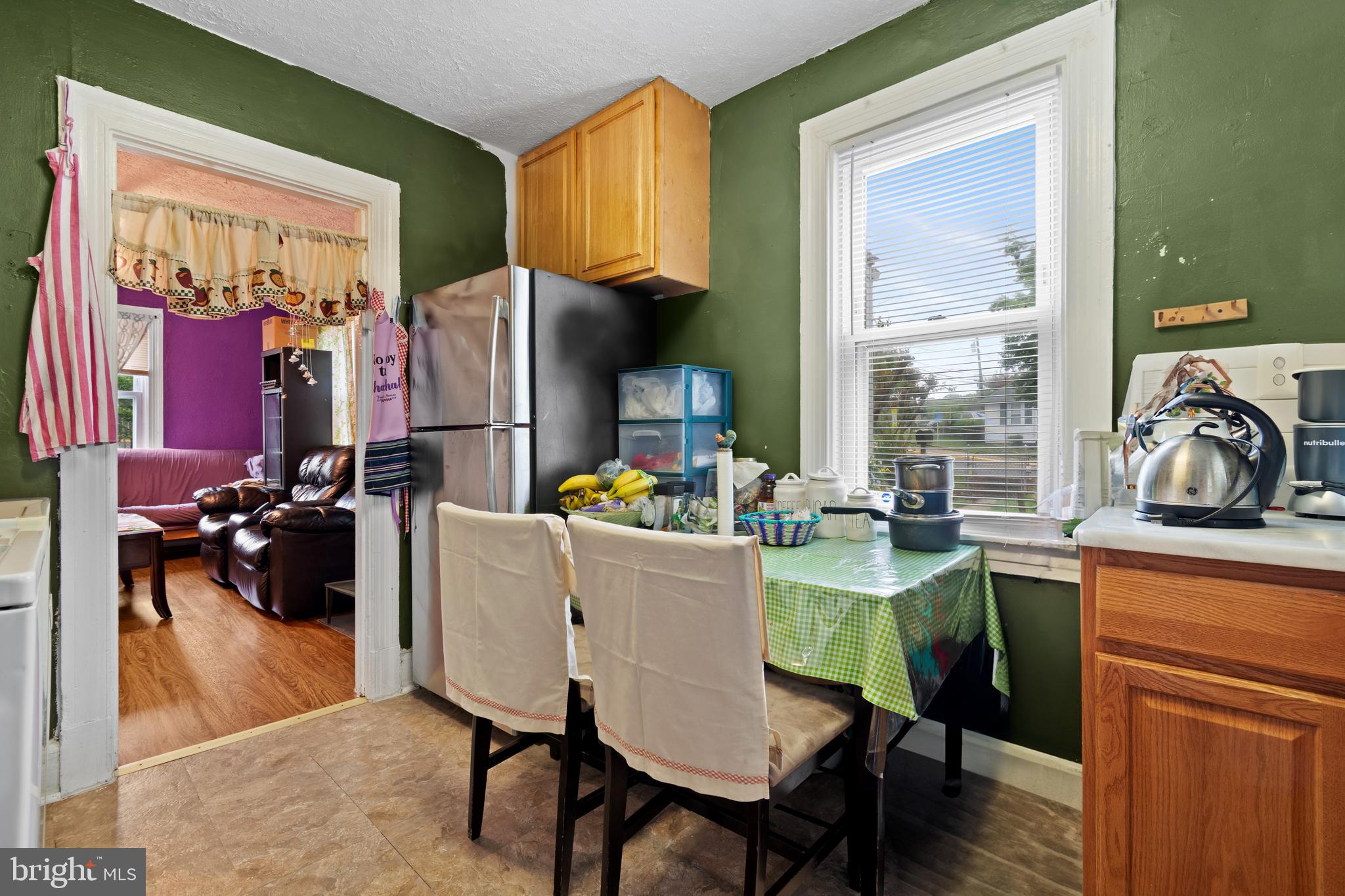 4410 Allies Road Suitland, MD 20746 - Photo 13 of 30 a dining room with furniture and a floor to ceiling window