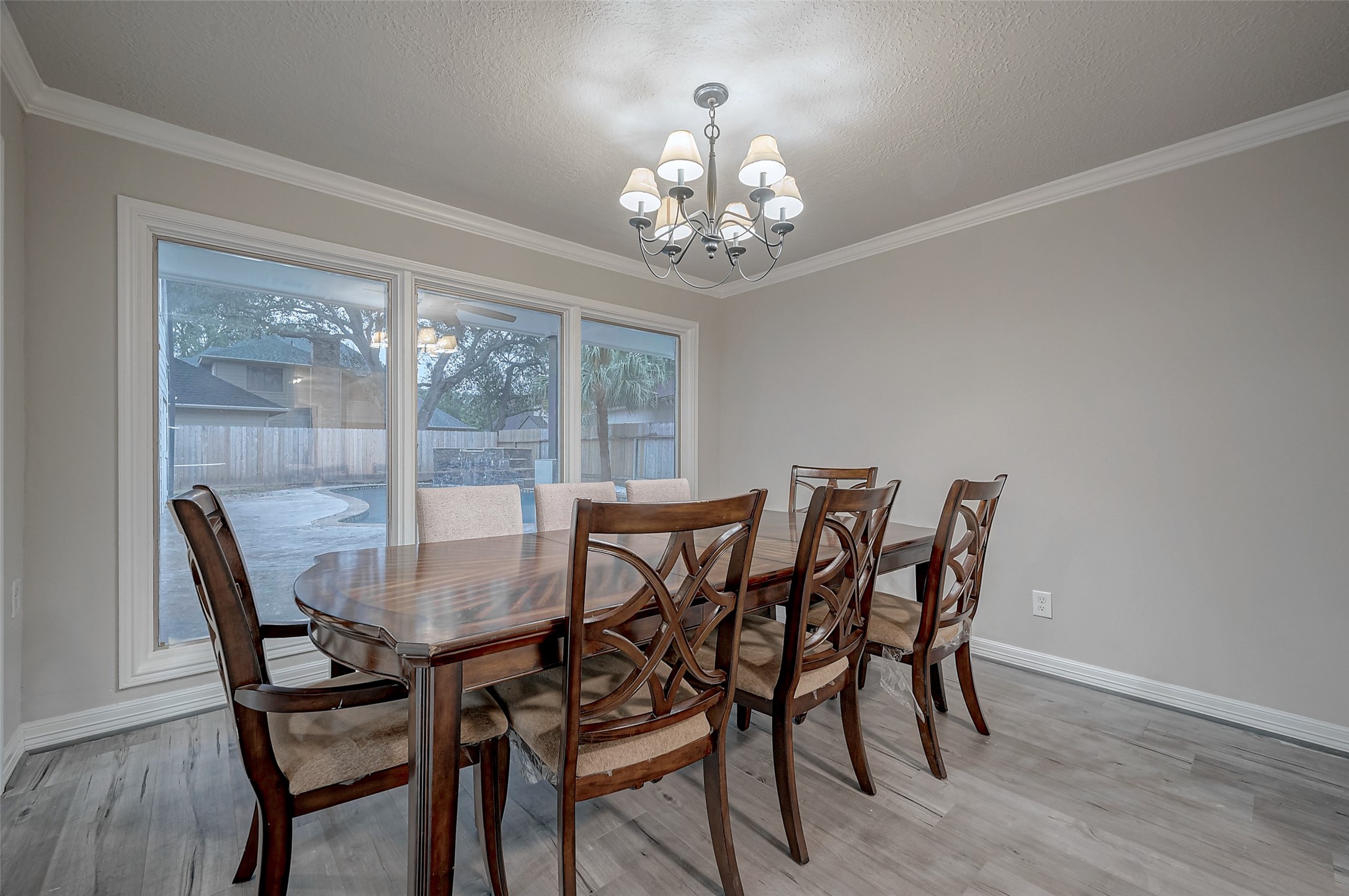 919 Mockingbird Way Sugar Land, TX 77478 - Photo 12 of 41 a view of a dining room with furniture a chandelier and wooden floor