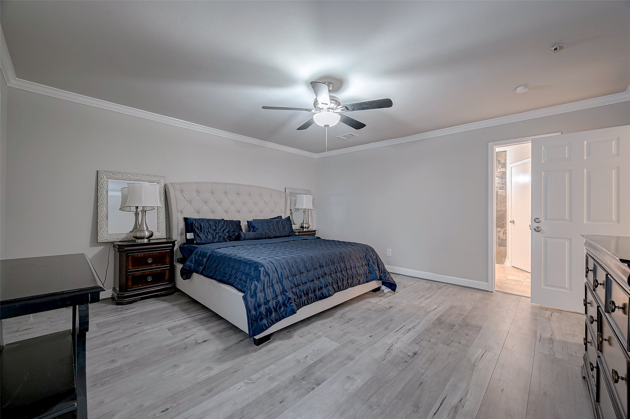 919 Mockingbird Way Sugar Land, TX 77478 - Photo 15 of 41 a bedroom with a bed and a chandelier