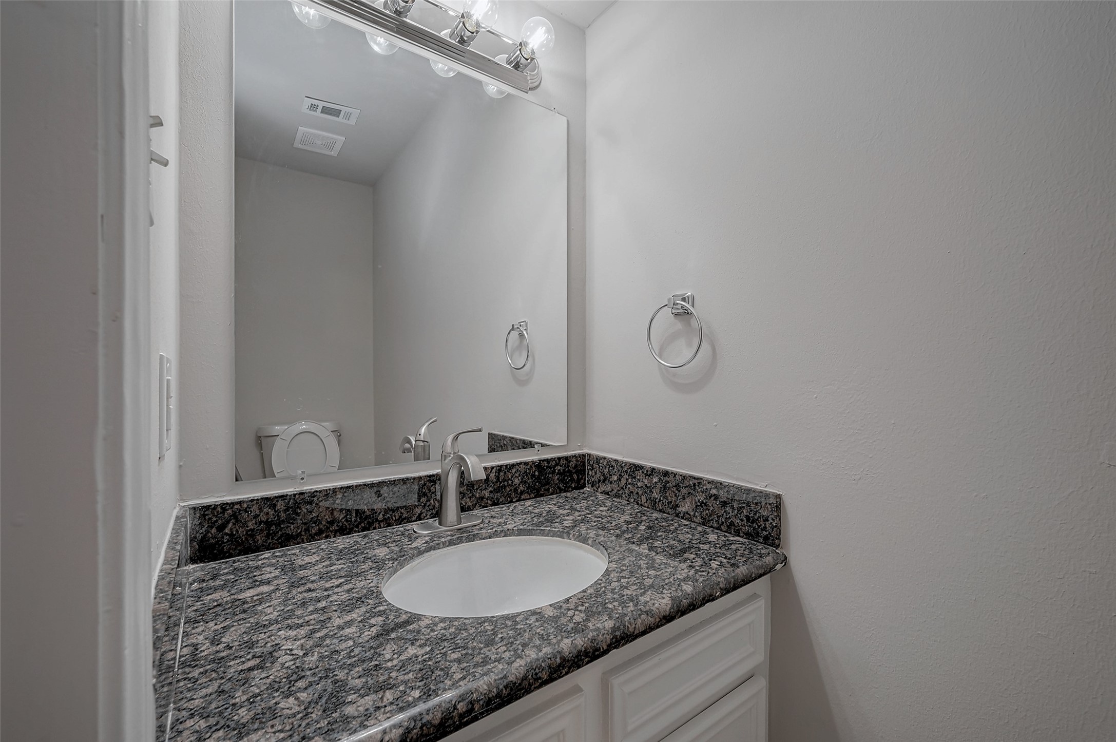 919 Mockingbird Way Sugar Land, TX 77478 - Photo 21 of 41 a bathroom with a granite countertop sink and a mirror
