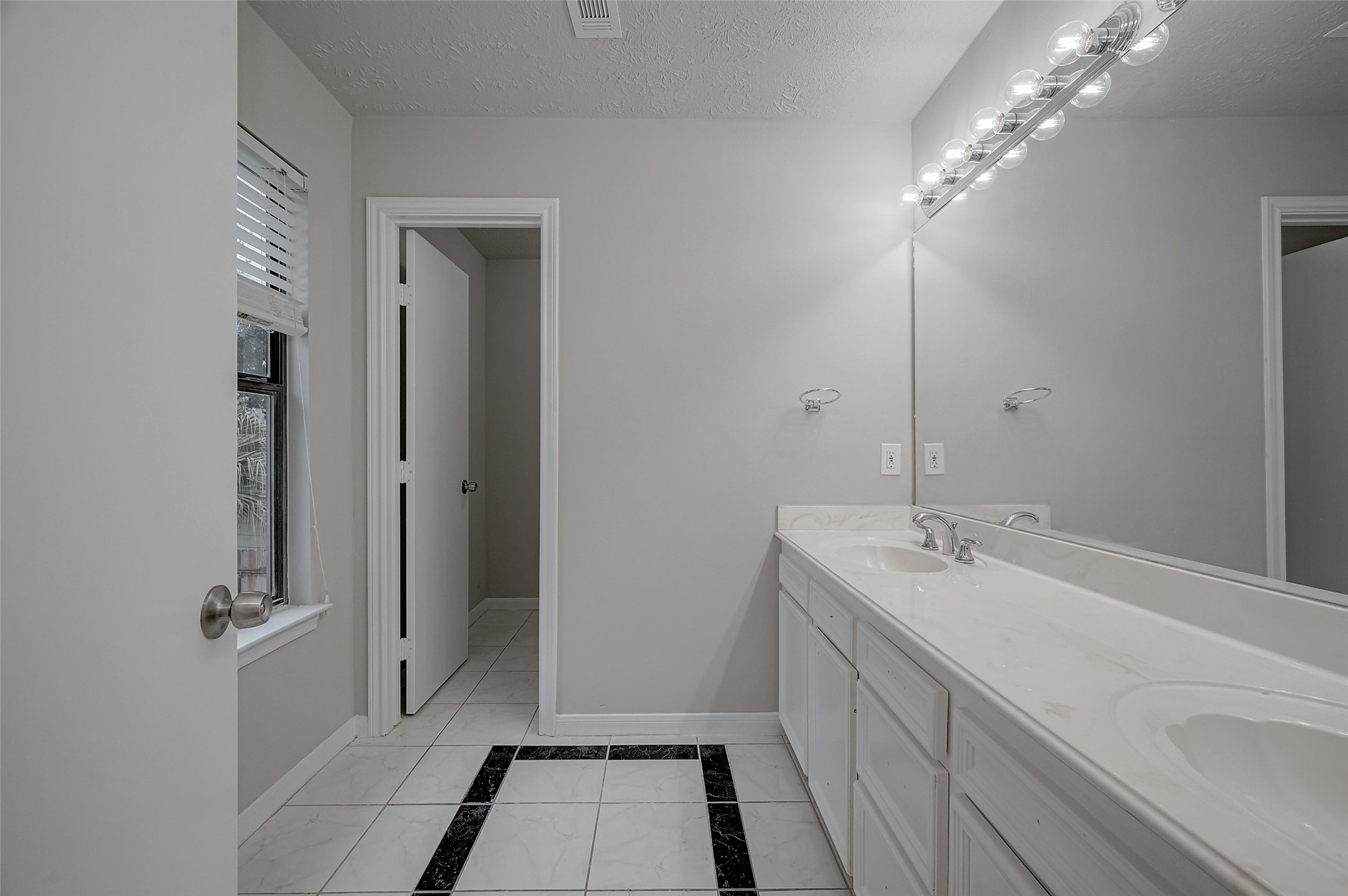 919 Mockingbird Way Sugar Land, TX 77478 - Photo 29 of 41 a bathroom with a double vanity sink and mirror