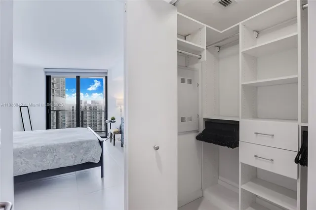 a bedroom with a bed and walk in closet