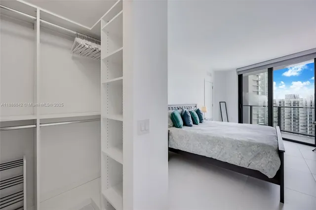 a room with a bed and large window