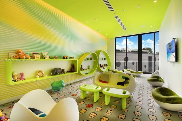 a living room with furniture and a floor to ceiling window