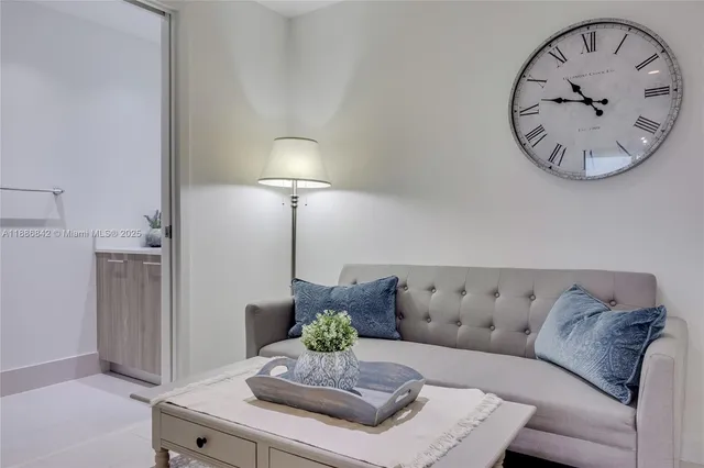 a living room with furniture and a mirror