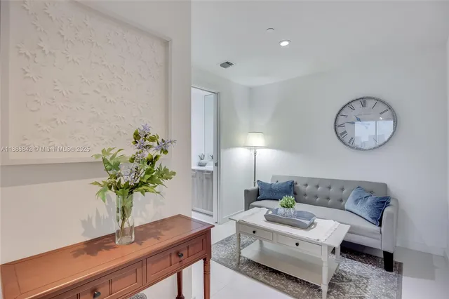 a living room with furniture potted plant and a lamp