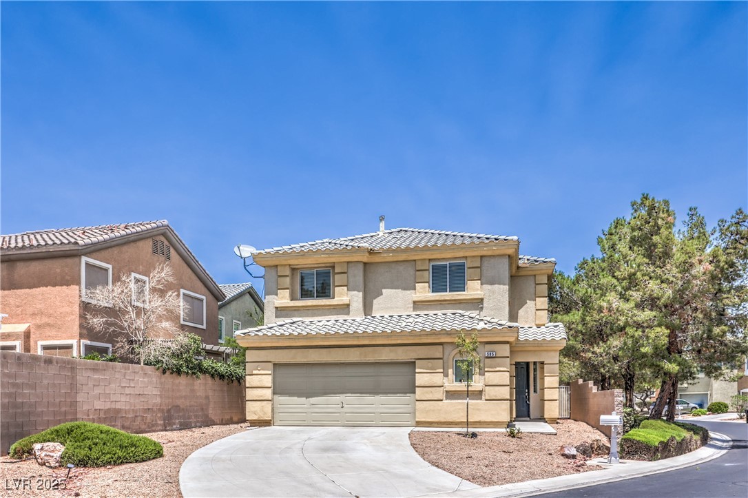 Mediterranean / spanish-style house with concrete driveway, a garage, a tile roof, and stucco siding