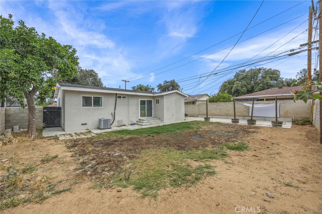 10028 Primrose Drive Riverside, CA 92503 - Photo 17 of 19 a view of a house with backyard and a tree
