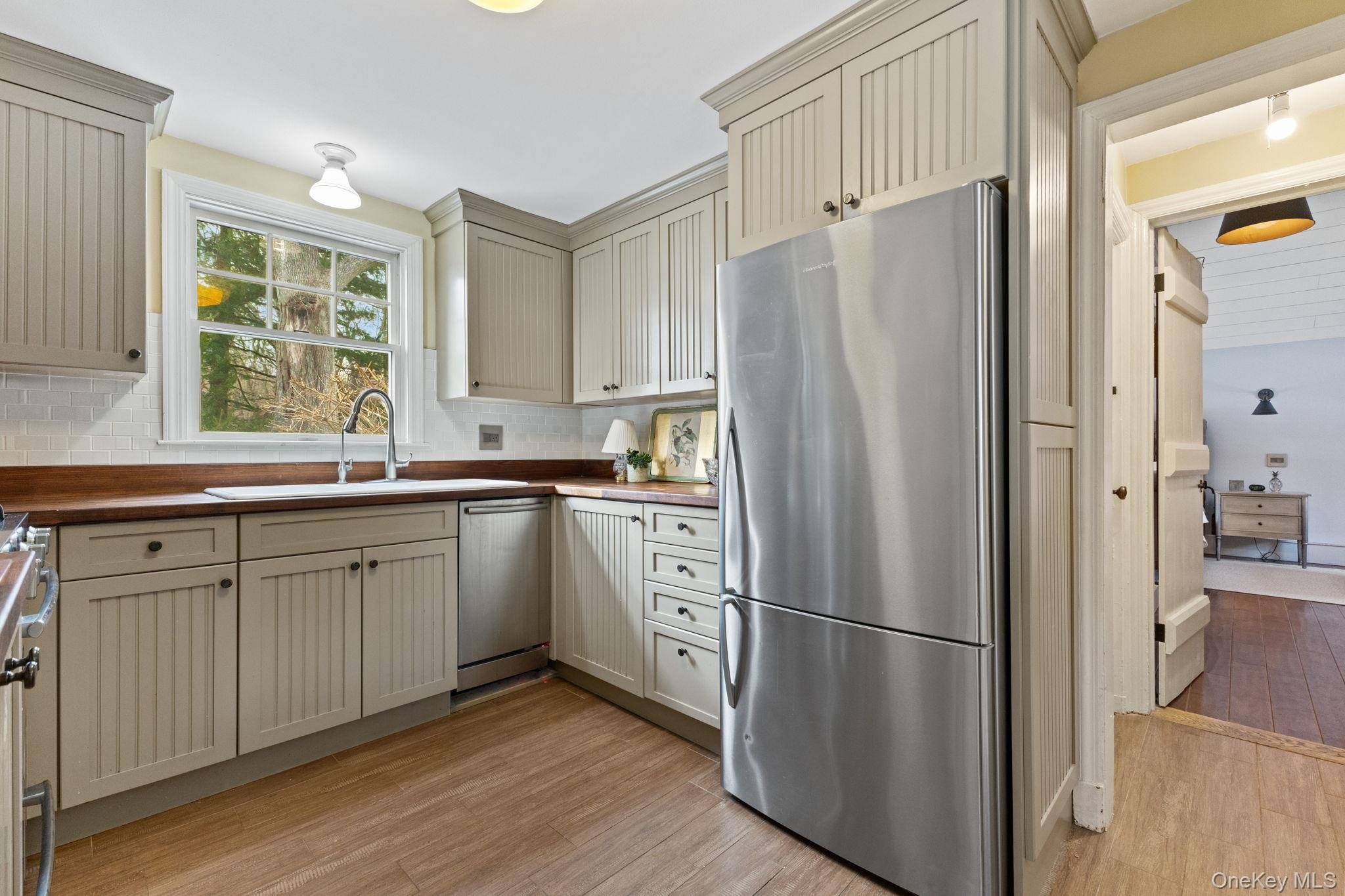 8 South Bedford Road Pound Ridge, NY 10576 - Photo 15 of 32 a kitchen with stainless steel appliances a refrigerator sink and cabinets